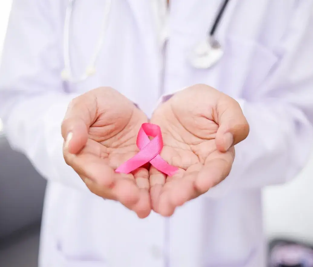 Hands holding a pink ribbon symbolizing breast cancer awareness – Spring Cleaning Services support October Pink