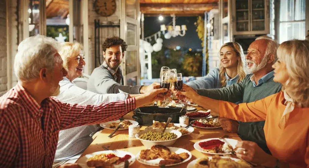 Family gathered around a festive Thanksgiving dinner table celebrating together